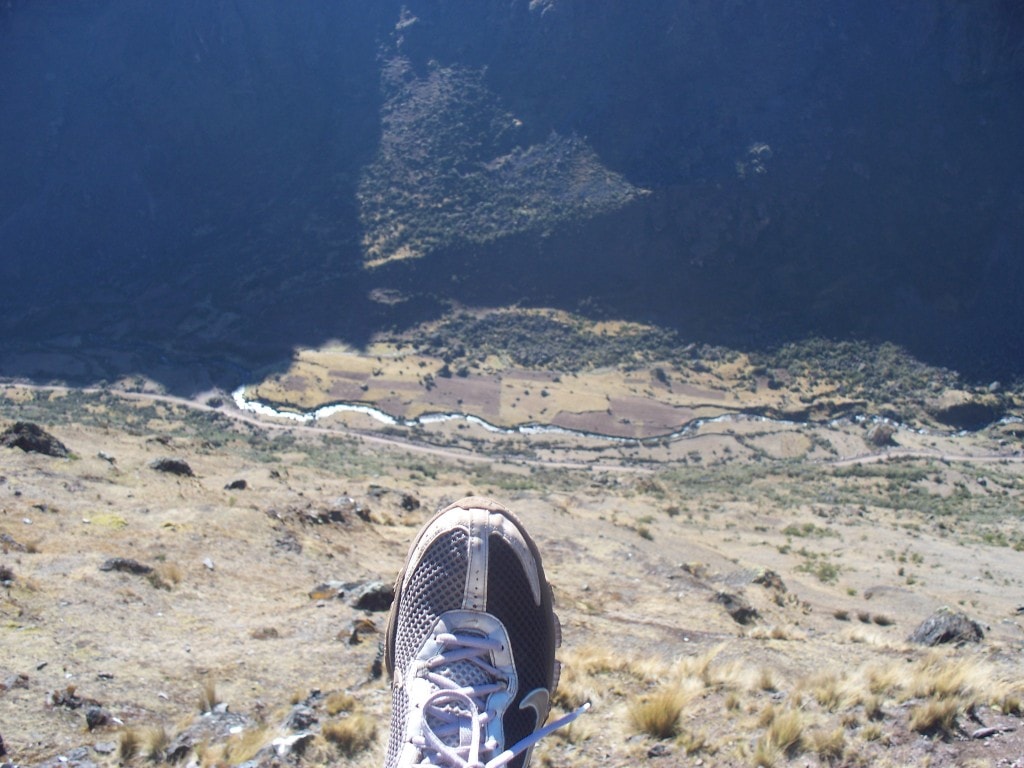 The Lares trek features some very impressive trails that lead along very steep cliffs.  Here I hang my foot over the edge to show the depth of the valley.