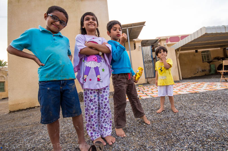 Kids pose for photos in an Omani fishing village