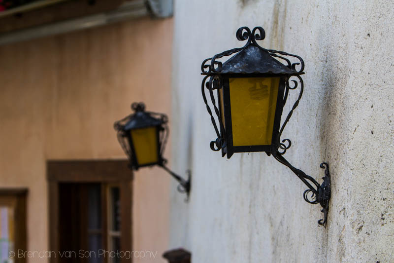 Old street lights along the stone walls of the old town. Shot at 85mm, f/3.5, 1/800sec., ISO 100
