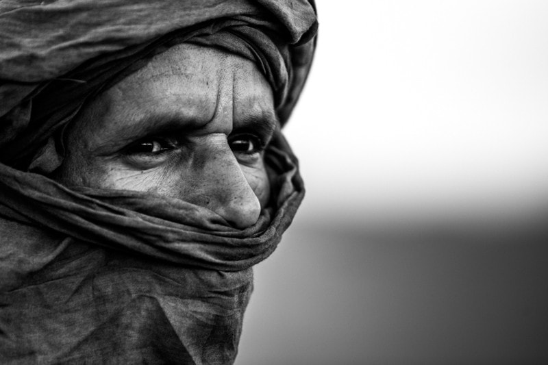 A local man poses for a portrait in the desert.