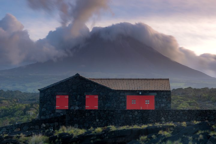 a house made of volcanic rock on Pico Island. Backdropped by the volcano.