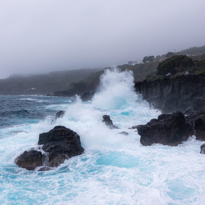 waves crashing onto cliffs on the island of Pico.